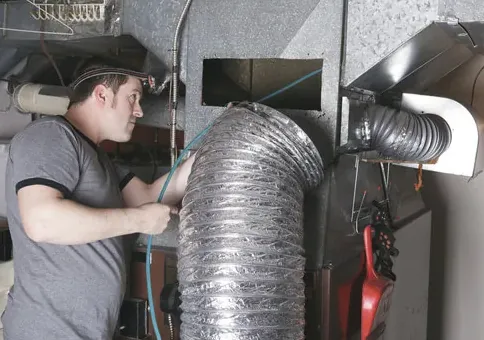 Flex duct being worked on at a furnace plenum